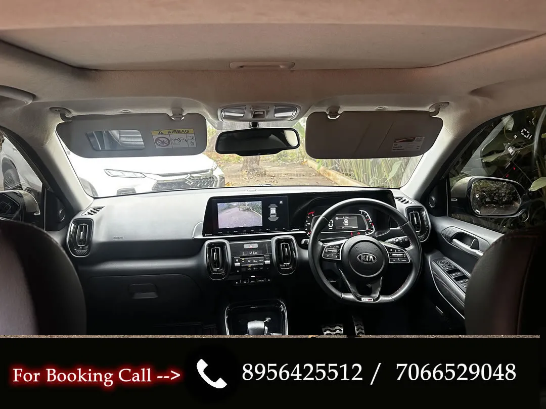 Detailed interior of the Kia Sonet, featuring the dashboard and front seats. Book this car rental in Goa.