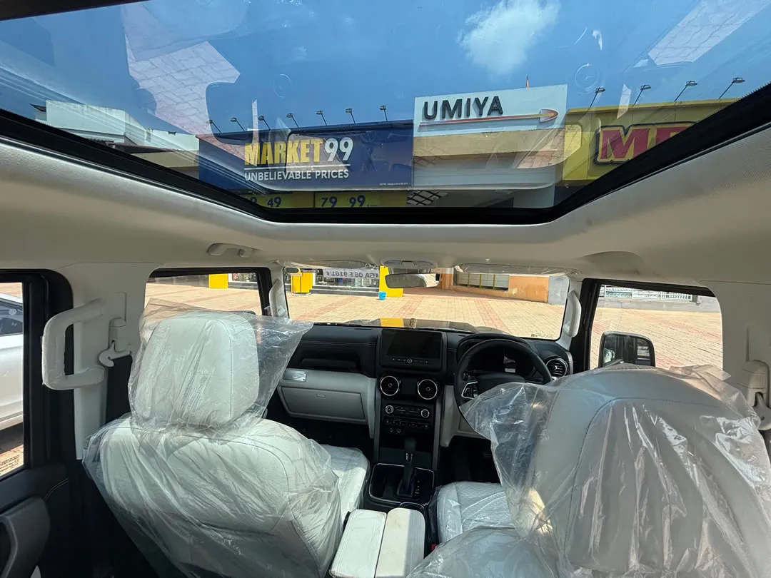 Interior of the Mahindra Thar ROXX, featuring the dashboard and seats. Book this car for your Goa adventure.