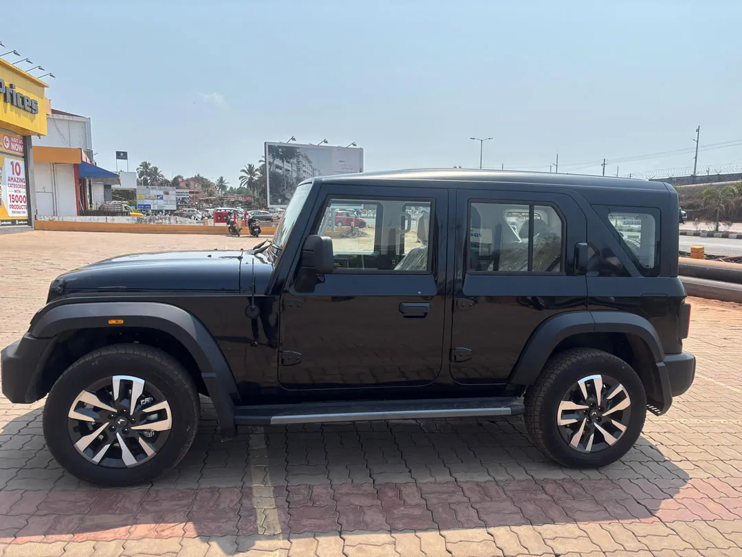 Left side view of the Mahindra Thar ROXX, a popular SUV for car hire in Goa.